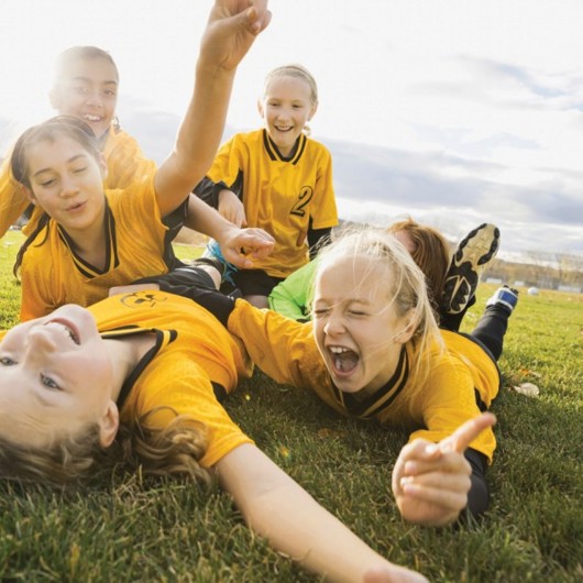 Five girls having fun on the grass