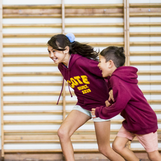 Girl and boy racing each other in the gym