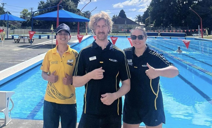 CLM staff at a pool posing for a picture