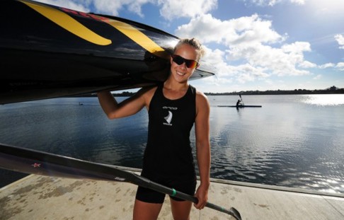 Lisa Carrington holding a canoe