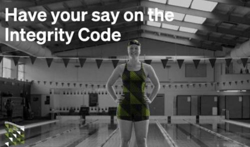 Female Swimmer standing in front of a pool