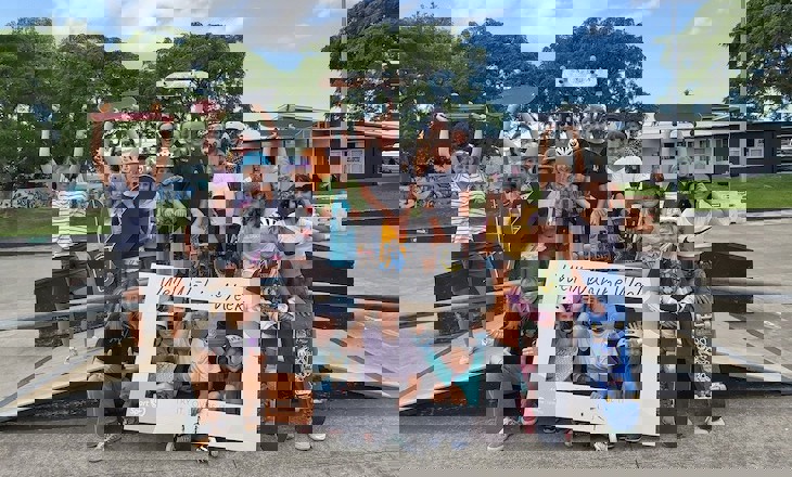 Group of young women holding up signs at skate park