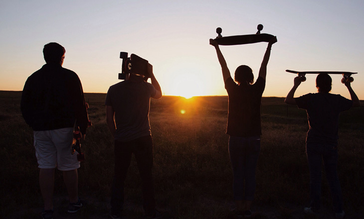 Skaters walking into the sunset
