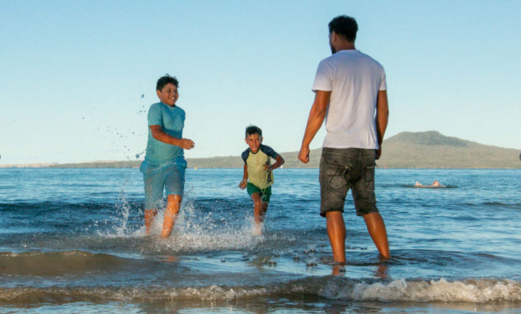 Family playing in the surf
