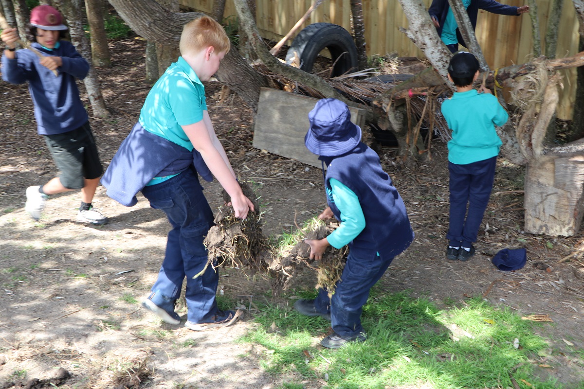 Children making a fort from spare parts and dirt