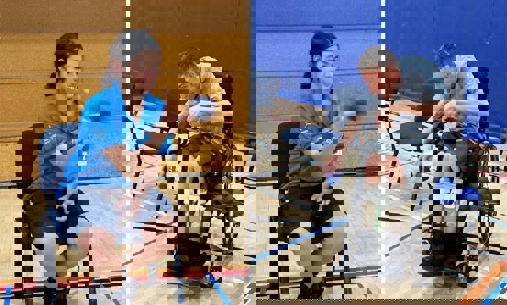 Girl in a chair and boy in a wheelchair catching a ball