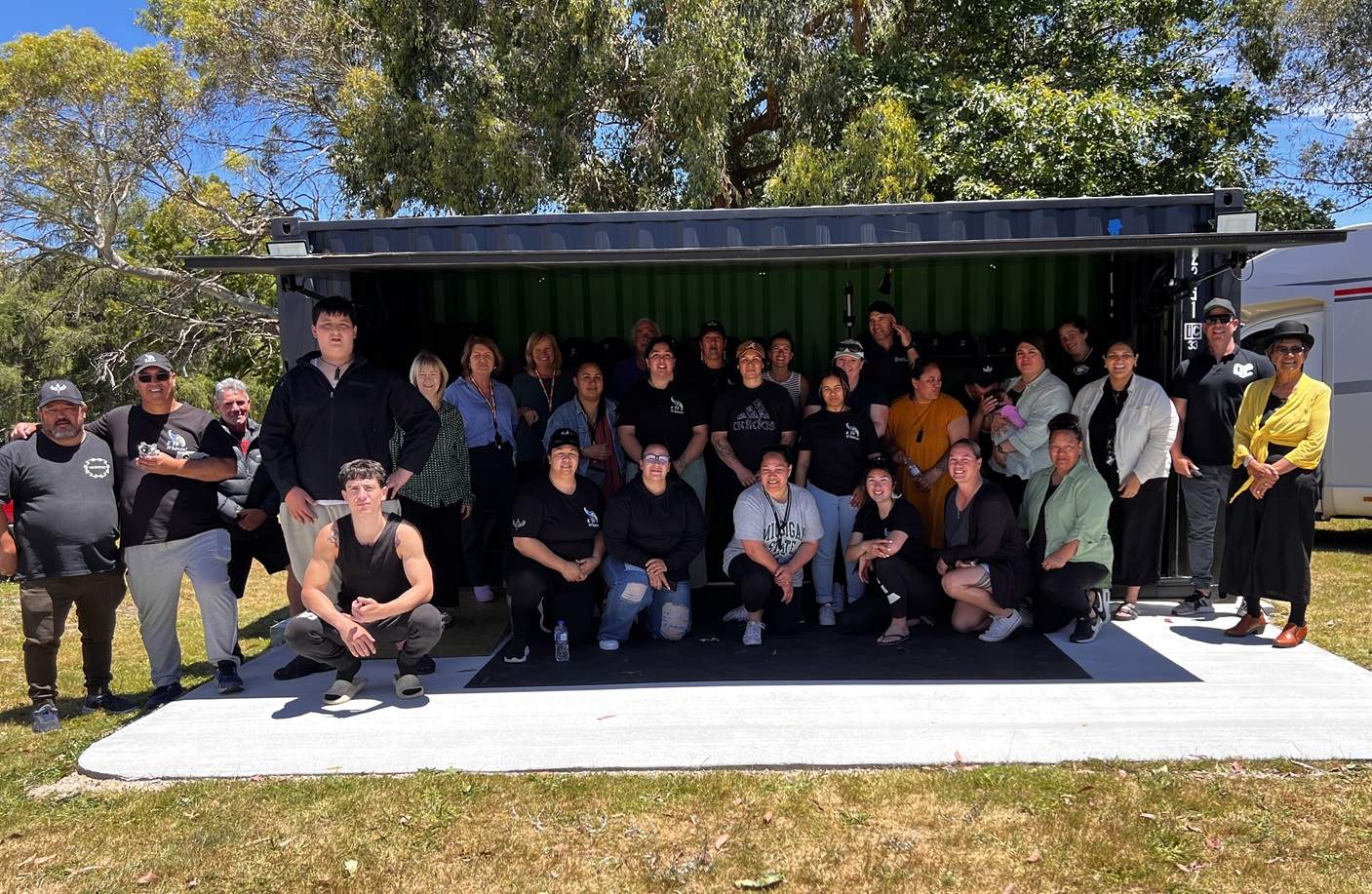 Group of people standing in front of a container