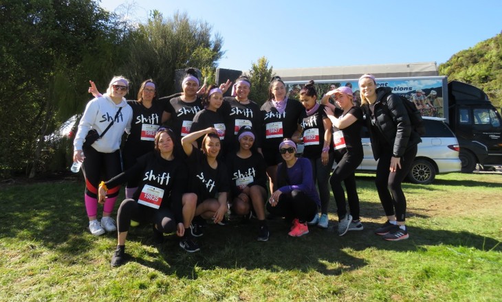 Young women standing as a group wearing SHIFT tshirts