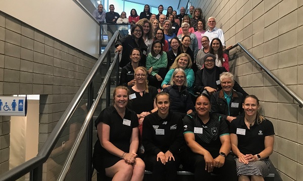 Group of people sitting on steps in a stairwell