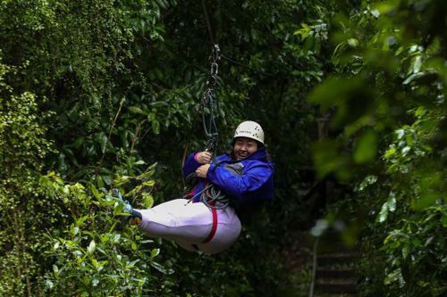 A woman on a zipline in the forest