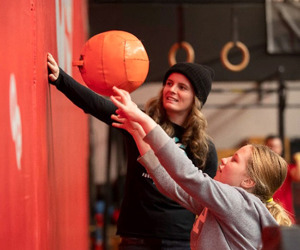 Tamariki throwing a ball at a wall