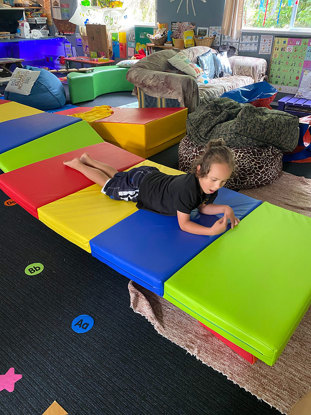 Tamariki playing on a mat